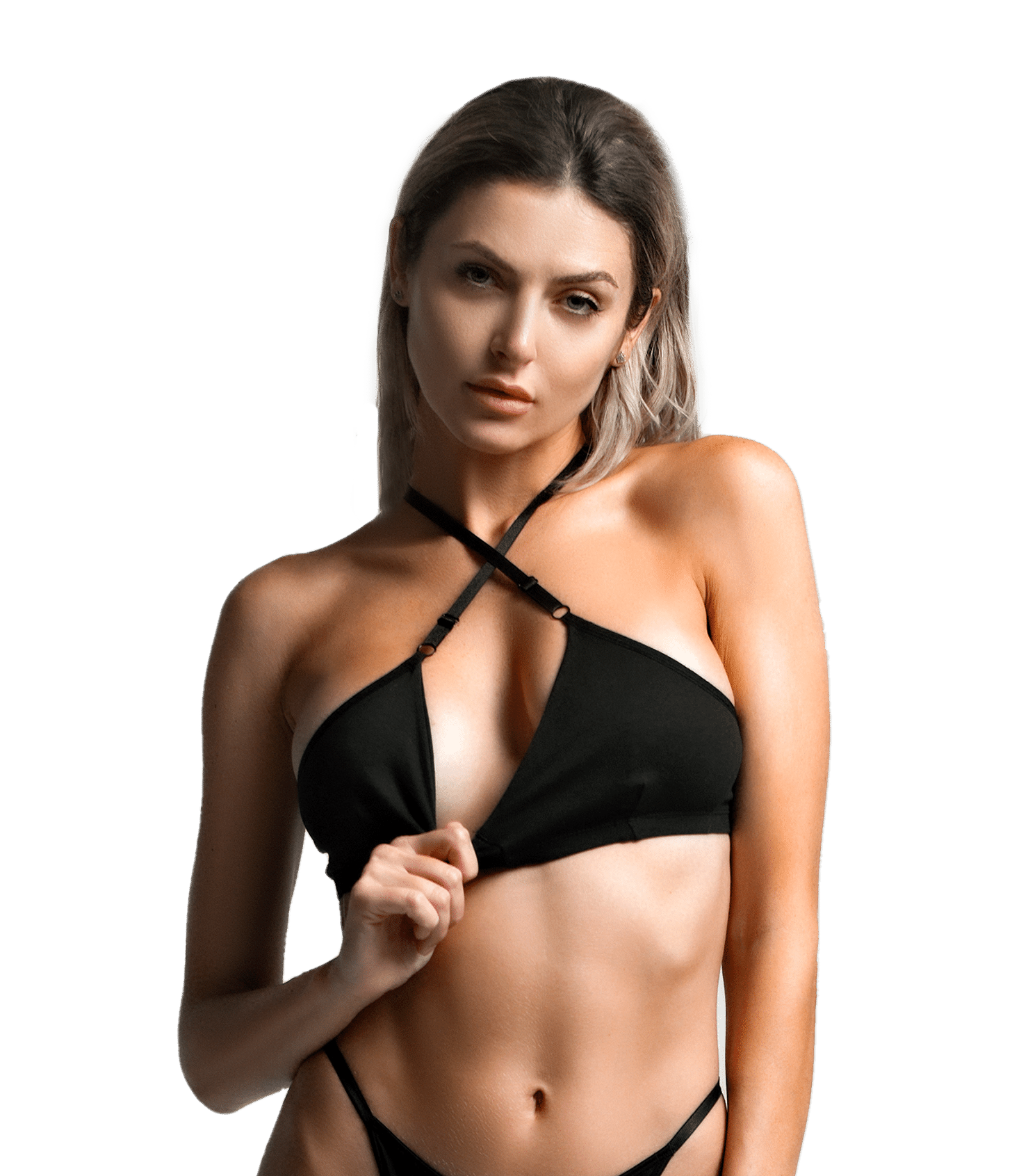Model posing in black swimwear against a green background.